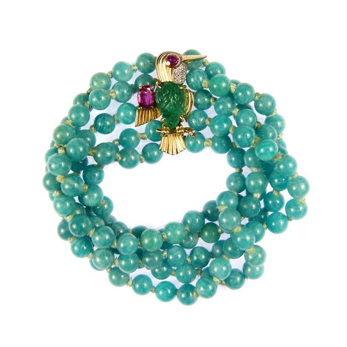   Cartier - Emerald, ruby and diamond bird brooch clasp on a multi-row amazonite bead bracelet | MasterArt